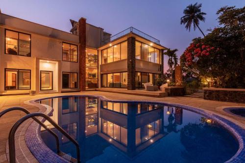 Nagaon Villa | Our Beloved Summer by StayVista - Offering a swimming pool, expansive lawn, badminton court and indoor games