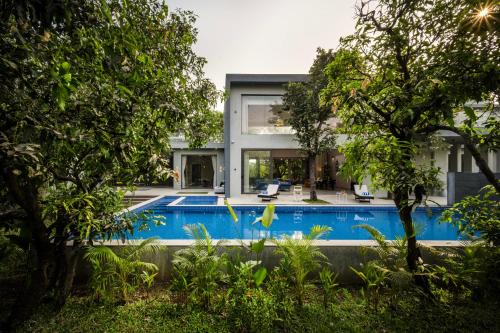 Alibaug Villa | SaffronStays Six Degrees - 6BR pool villa with high-ceiling interiors, lawns, swings & pool table near Awas Beach