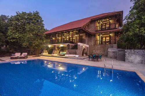 Suryamal Villa | SaffronStays Vedika - 4BR riverfront pool villa with kaya king bullock ride & BBQ near Pinjal River, Vikramgad
