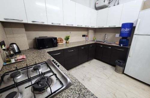 Greater Kailash Apartment | Air Purifier - Sun-lit 1BHK Suite with big kitchen 9