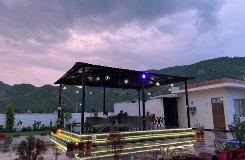 Alwar House | Nestled amidst majestic mountains, our farmhouse offers a serene and picturesque