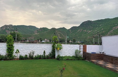 Alwar House | Nestled amidst majestic mountains, our farmhouse offers a serene and picturesque