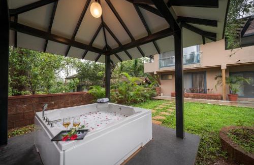Wai Villa | SaffronStays Red Brick House - 3BR English-style villa with verandah dining, orchard lawn & classic charm
