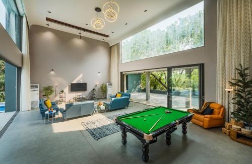Alibaug Villa | SaffronStays Six Degrees - 6BR pool villa with high-ceiling interiors, lawns, swings & pool table near Awas Beach
