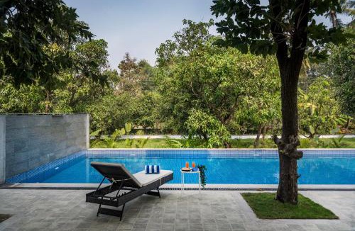 Alibaug Villa | SaffronStays Six Degrees - 6BR pool villa with high-ceiling interiors, lawns, swings & pool table near Awas Beach