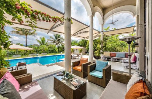 Kadadhe Villa | SaffronStays Zuma Villa - 7BR pet-friendly villa with heated pool, 6000 sqft lawn, play zone & cards room near Pawna Dam
