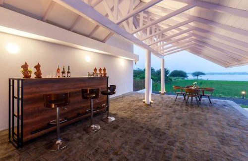 Nashik Villa | StayVista's Eva Villa - Lakeside Luxury with Modern Decor, Pool & Expansive Lawn - Near Sula