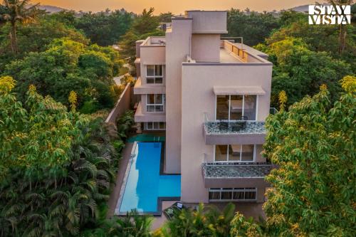 StayVista's Rosso with Outdoor Pool, Theatre-Disc Room & Games Room